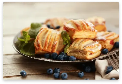 Puff pastry with cheese filling arranged in decorative web pattern