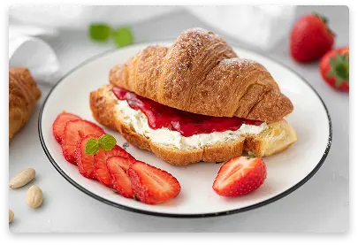 Golden croissant filled with sweet strawberry filling