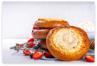 Individual cheesecake pastry with creamy filling and powdered sugar dusting